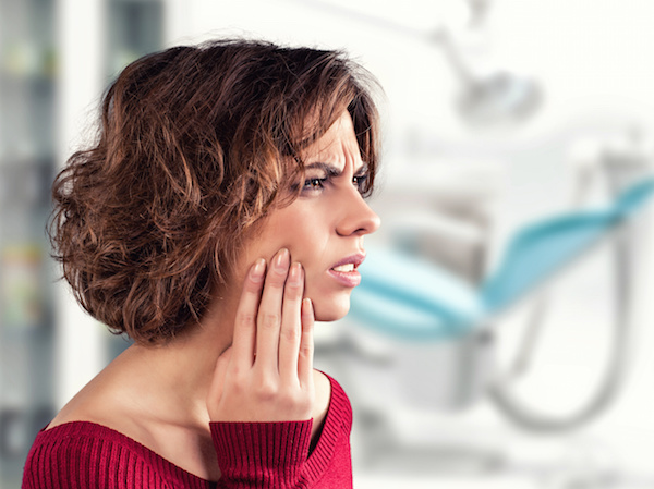 Girl with a painful tooth in a medical office Dr. Joe Thomas Dentistry