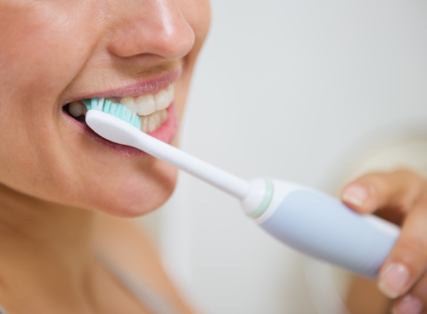 closeup of woman brushing teeth Dr. Joe Thomas Dentistry